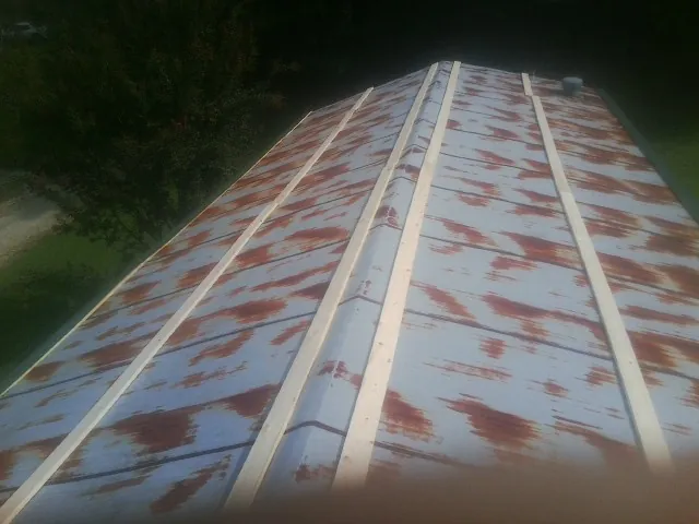 Rusted metal roof panels with new wood purlins before replacement — Storm Damage Roof Repair in Great Mills by Roofing Brothers